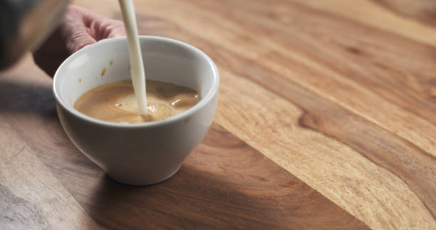 istock steamed milk pour into coffee cup to make cappuccino 1497345320