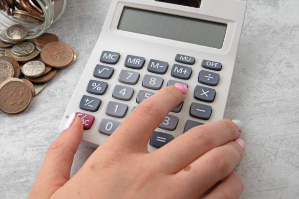 istock Fingers on calculator marble back ground 1497347255