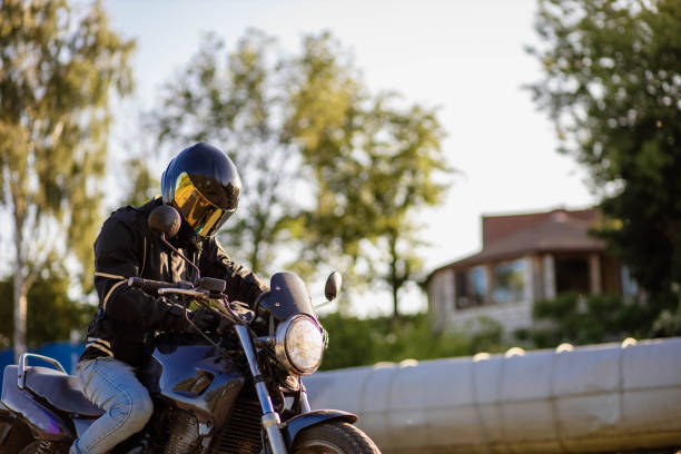 istock motorcyclist in gear and a helmet with a sun visor on a motorcycle in summer 1497347324