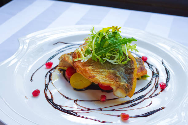 istock Crispy seared sea bass with pomegranate seeds and balsamic vinegar garnish 1497347998