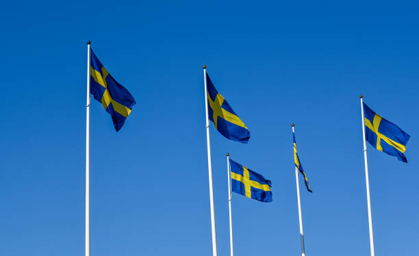 istock Swedish flag on flag pole and clear blue sky 1497348099