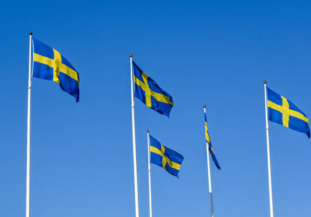 istock Swedish flag on flag pole and clear blue sky 1497348209