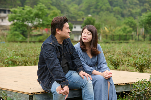 Young Asia couple visit tea garden.