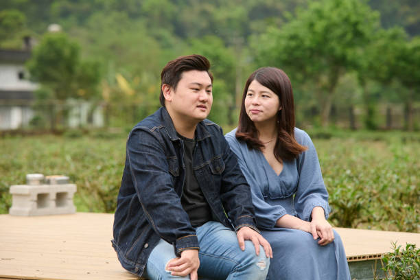 istock Young Asia couple visit tea garden. 1497348516