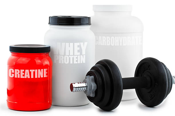 Sport Nutritional Supplement containers with dumbell stock photo