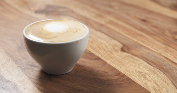 steamed milk poured into coffee cup to make cappuccino