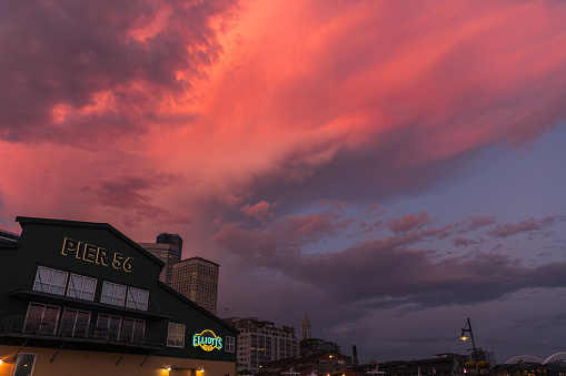 Seattle, USA - May 15, 2023: Late in the day a vivid sunset over pier 56.