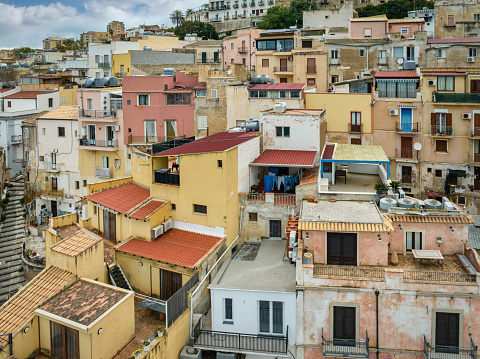 Sciacca Village Cityscape with residential houses built up to the hill under blue summer sky. Hill Range typical Sicilian Old Town Buildings. Sciacca, Agrigento, Sicily Island, Southern Italy, Southern Europe.