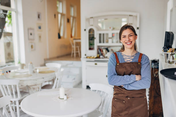 istock A smiling waitress looks directly into the camera while standing in the restaurant where she works 1497357233