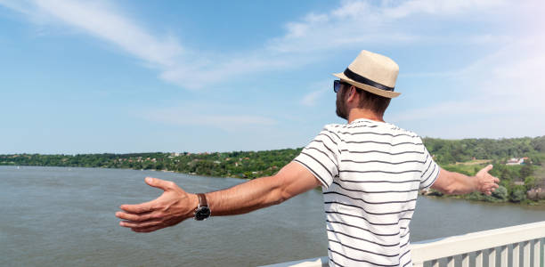 Boy enjoying on a cruise ship. He is standing on a terrace