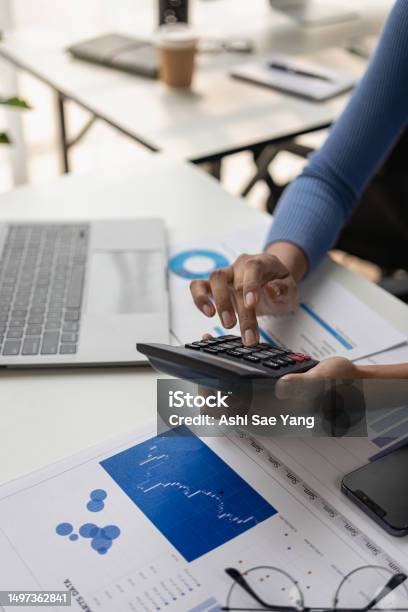 Accountant Using Risk Management Process Calculator With Running Market Reports Touchscreen Documents Tablets Using Graphic Icons Global Stock Market Reports Starting Business Projects Vertical Stock Photo - Download Image Now