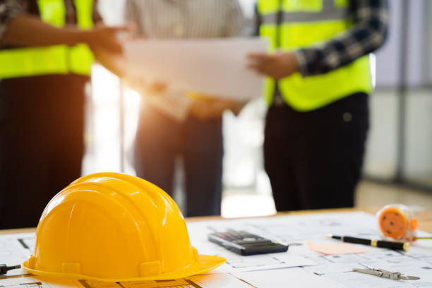 istock Engineer teams meeting working together wear worker helmets hardhat on construction office. 1497366183