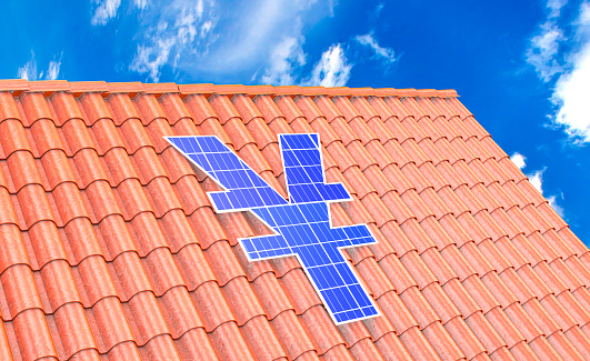 Solar panel in the form of a Yen sign on a roof made of roof tiles
