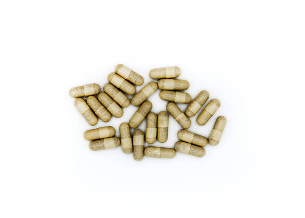 istock Top view of white or brown pills or capsule isolated on white background. 1497367974