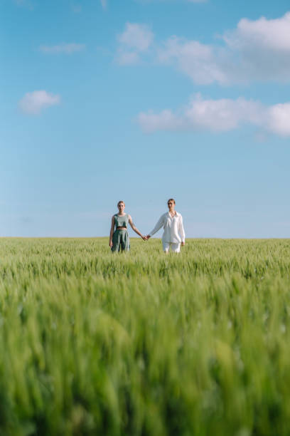 istock Two Beautiful woman posing in the green field. 1497371482