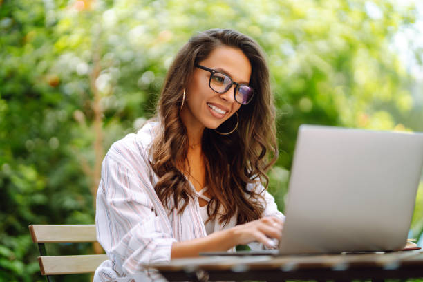 istock Young woman sitting on cafe with laptop. 1497371565
