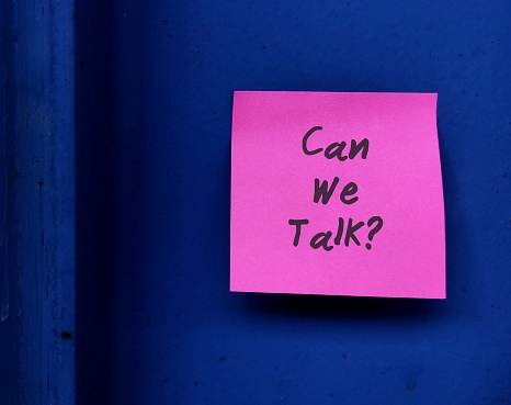 Pink note on blue walll with text written CAN WE TALK , concept of talk openly to improve relationship, listen and share more, for couples or for teamwork