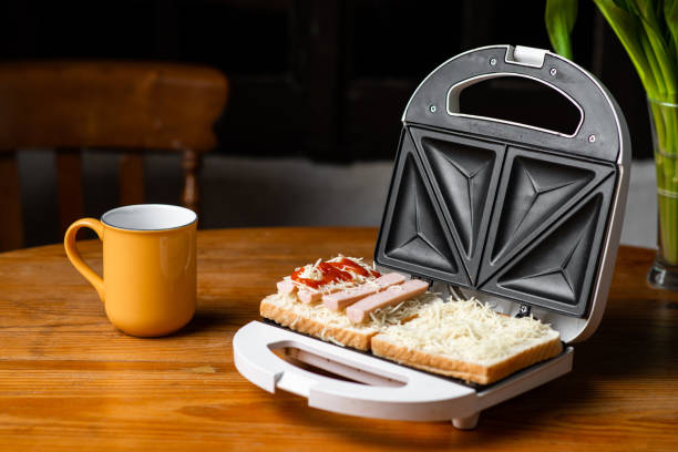 istock open sandwich maker with cheese toast and sausages. Sandwiching. 1497378377