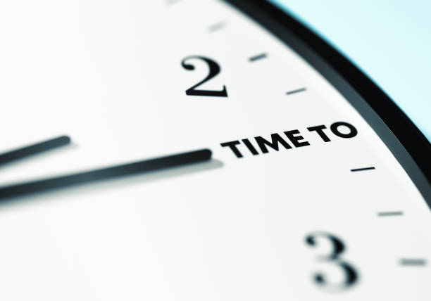 Time to Time. The time on the wall clock is showing Time to. Time, deadline and Planning Concept. Close Up Wall Clock And Time is passing.