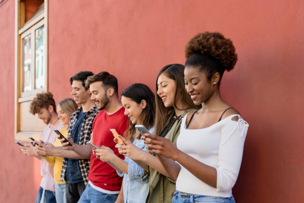 istock Young multiracial group of friends using mobile smartphone outdoor - Millennial generation having fun with new trends social media apps - Youth technology people addicted 1497387128