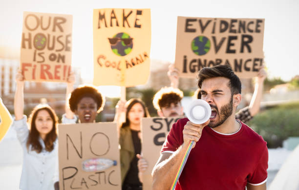 istock Group of activists protesting for climate change - Multiracial people fighting on road holding banners over environments disasters - Global warming concept 1497387259