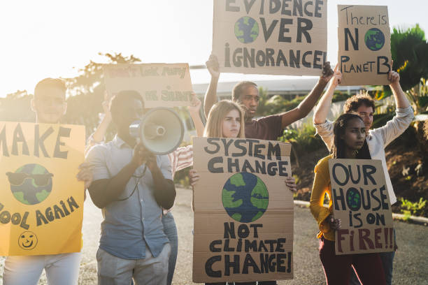 istock Group of activists protesting for climate change - Multiracial people fighting on road holding banners over environments disasters - Global warming concept 1497392167