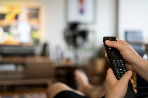 istock Addiction to watching TV watching human hand 1497393509