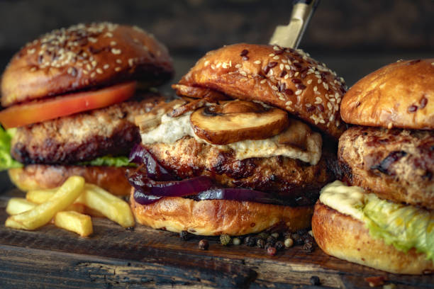 istock Three different brutal burgers on wooden board 1497395535
