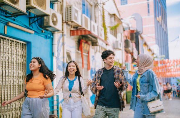 multiracial Asian young friends enjoy walking in city street together Lifestyle Asian friends walking together at old town center having fun University students on travel vacations travel stock pictures, royalty-free photos & images