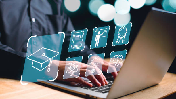 istock Man using laptop on desk with education icons and blue bokeh light background. Digital technology platform and courses concept. Online E-learning and training lessons on internet webinar theme. 1497400140
