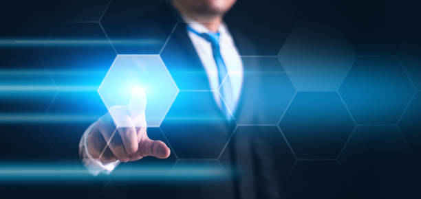 Businessman touching and pressing hexagon honey screen display hologram button interface by finger on dark black background. Internet and Virtual Reality concept. Business and technology theme.
