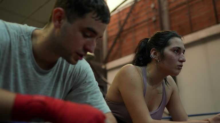 Young boxers tired while talking in the ring