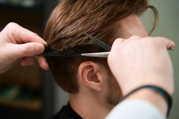 istock Barber making haircut to his client in room 1497402226