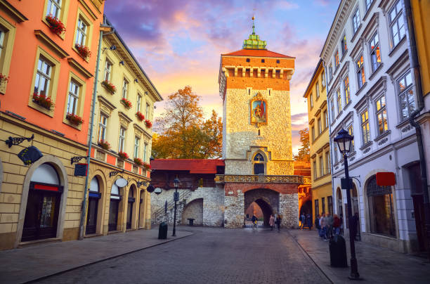 Krakow, Poland. Saint Florian Gate (Florianska or Brama) with tower. Famous ancient landmark in krakow old town. Picturesque street morning sunrise and lamps