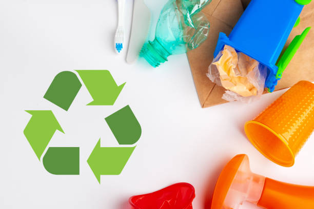 istock waste recycling eco symbol with garbage disposal on table background top 1497406549