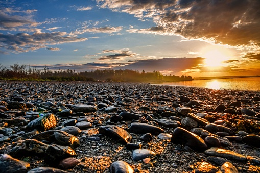 A sunrise at Lamoine Beach in Maine. With the rocky terrain and fresh coastal water, this makes the perfect travel destination to relax with Acadia National Park off in the horizon.