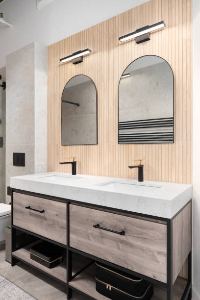 istock A modern bathroom with a wood slat wall and arched mirrors. 1497413907