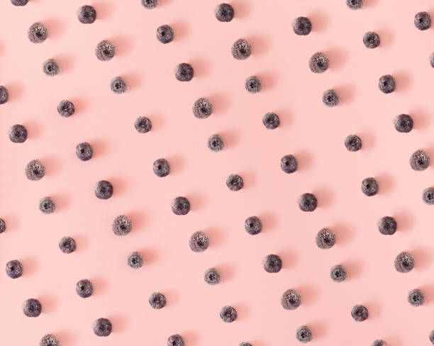 istock Frozen juicy blueberries on pink background. Blueberries background. Flat lay top view copy space. Healthy berry, organic food, antioxidant, vitamin, blue food. Blueberry pattern 1497418703