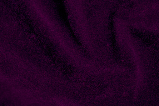 Purple velvet fabric texture used as background. violet fabric background of soft and smooth textile material. There is space for text.