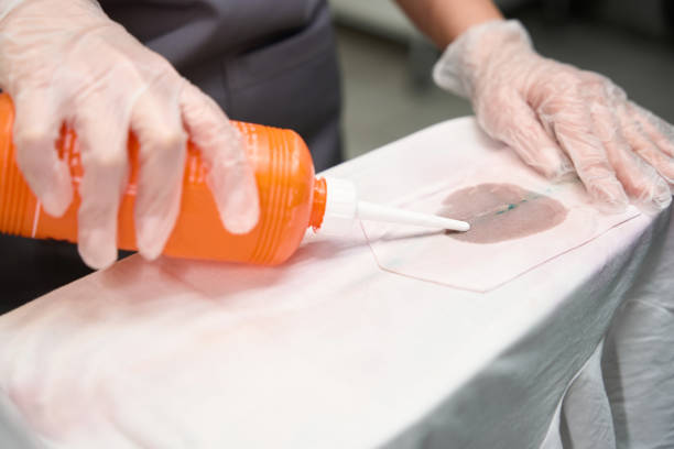 istock Laundry worker treating dirty spots on clothes before dry cleaning 1497419528