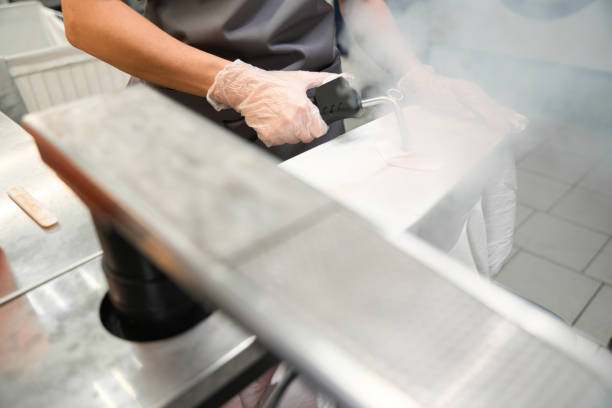 istock Dry-cleaning service worker treating clothing with steam 1497419569