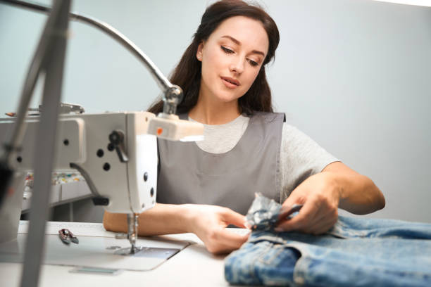 istock Dry-cleaning office worker covering buttons and embellishments 1497420784