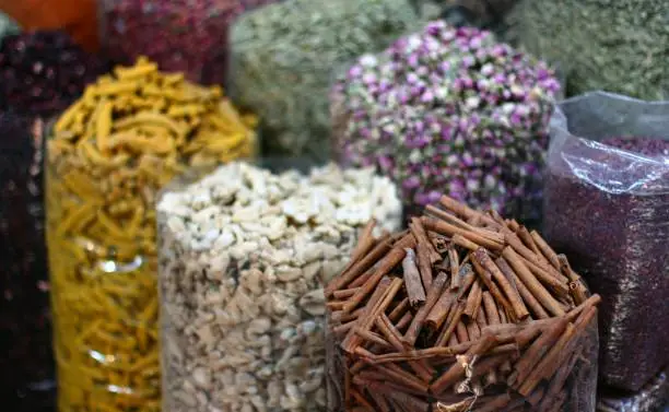 An assortment of dried herbs in various quantities arranged in a neat, organized display