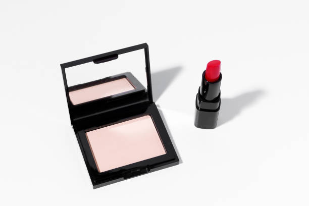 istock Compact mirror matte face powder and red women's lipstick on white isolated background. Concept of beauty, decorative cosmetics, face care and make-up products. 1497422676