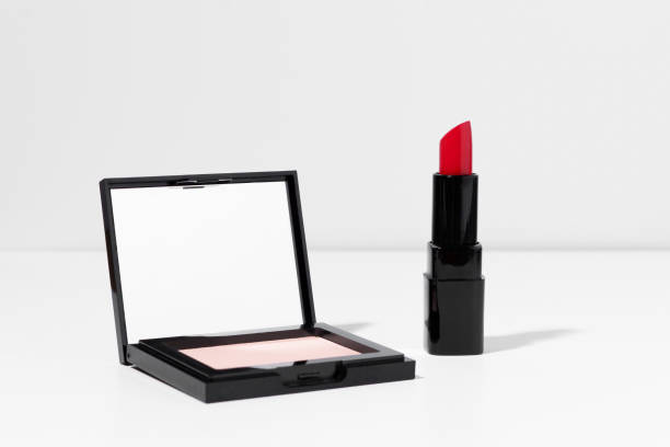 istock Compact mirror powder and decorative red lipstick for face makeup on a white background. Beauty and aesthetics concept, face care concept. 1497422741