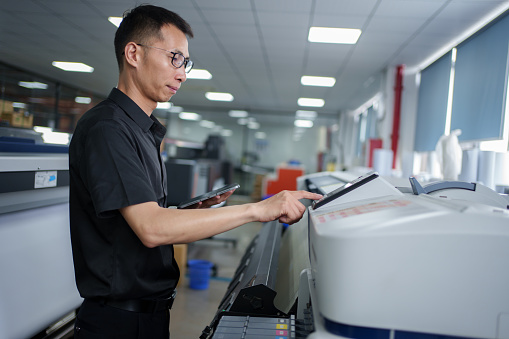 Engineer inspects intelligent printing machine