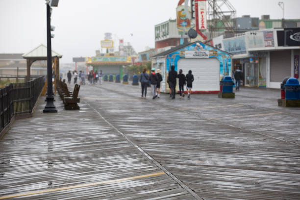 Seaside Heights, New Jersey, USA - May 20, 2023: Daytime view of the mostly empty boardwalk on an overcast rainy day.