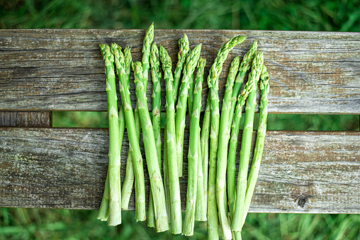 Young asparagus on wooden background. Healthy, vegetarian food concept.