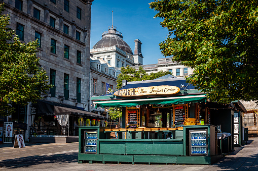 Postcard view at classic street cafe-shop in Paris, France (the building on the left hand is Louvre)