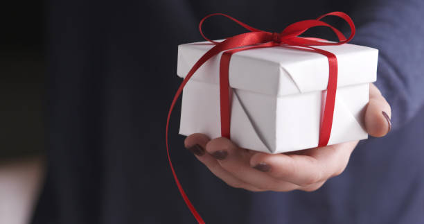 istock young girl show white gift box with red ribbon 1497437526